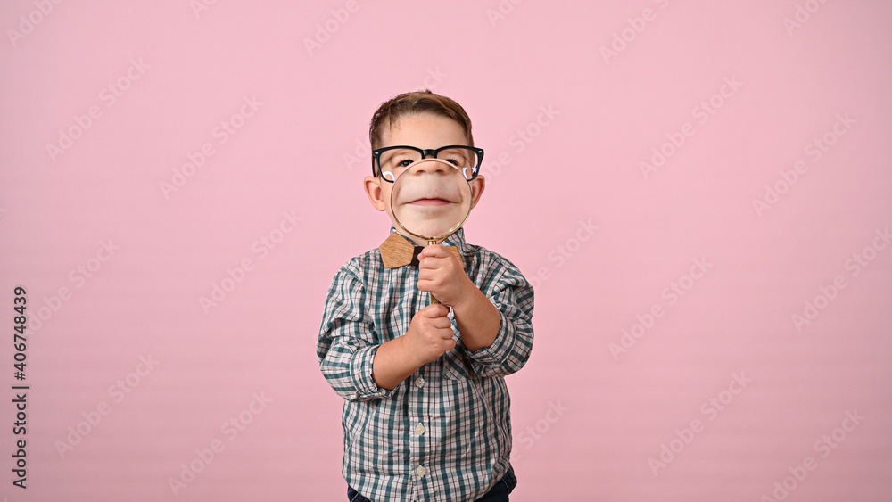 Child shows mouth with magnifying glass Child shows mouth with magnifying glass