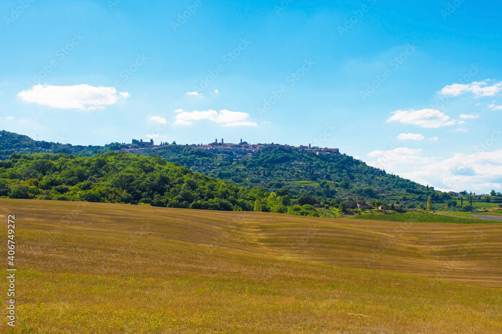 The late summer landscape around Montalcino in Siena Province, Tuscany, Italy. The town of Montalcino can be seen on the hill in the background
