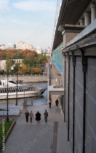 Large white pleasure motor ship passes under the Metro bridge, view of Luzhnetskaya embankment, autumn 2020, Moscow photo