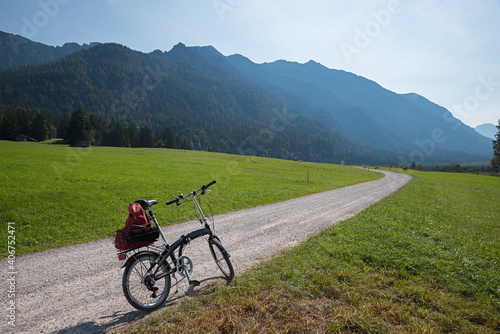 bike tour in alpine landscape with a folding bicycle, upper bavaria