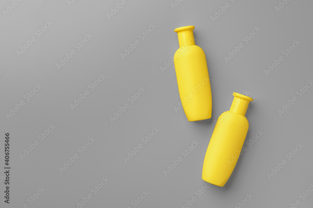 Yellow cosmetic container on gray background top view Yellow cosmetic container on gray background top view