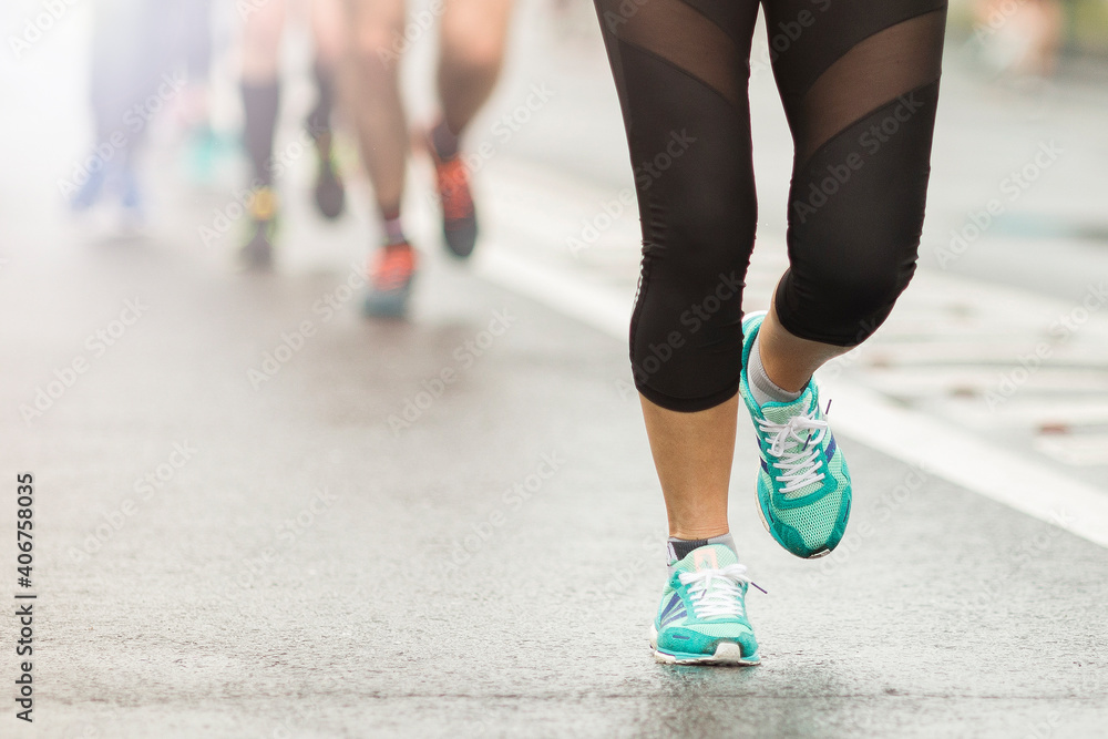 Marathon running race people competing in fitness and healthy active lifestyle feet on road