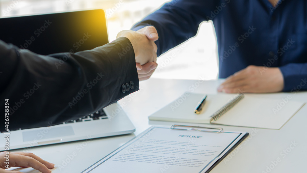 Job seekers and employers shake hands and submit resume for job interviews. Quality employment concept Job seekers and employers shake hands and submit resume for job interviews. Quality employment concept