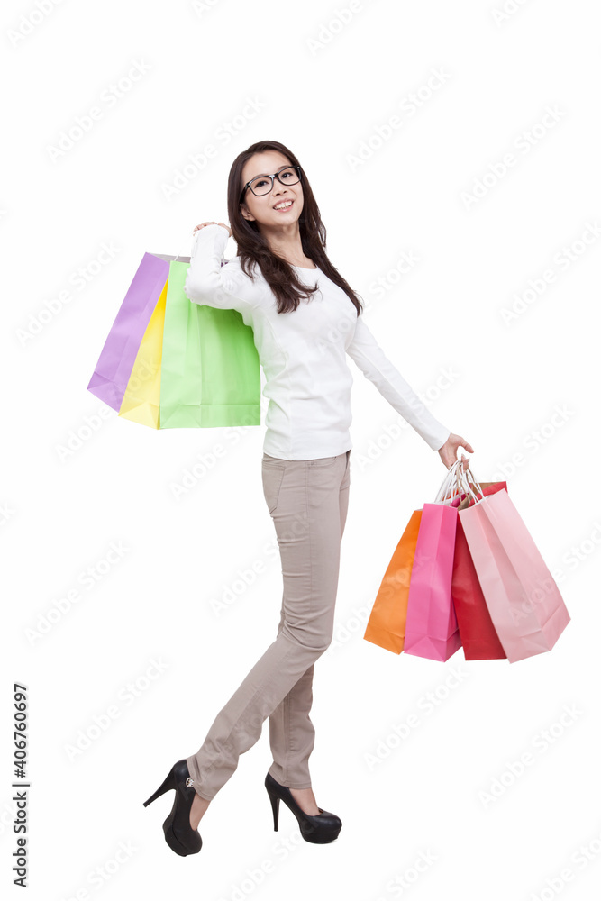Portrait of young female holding shopping bags