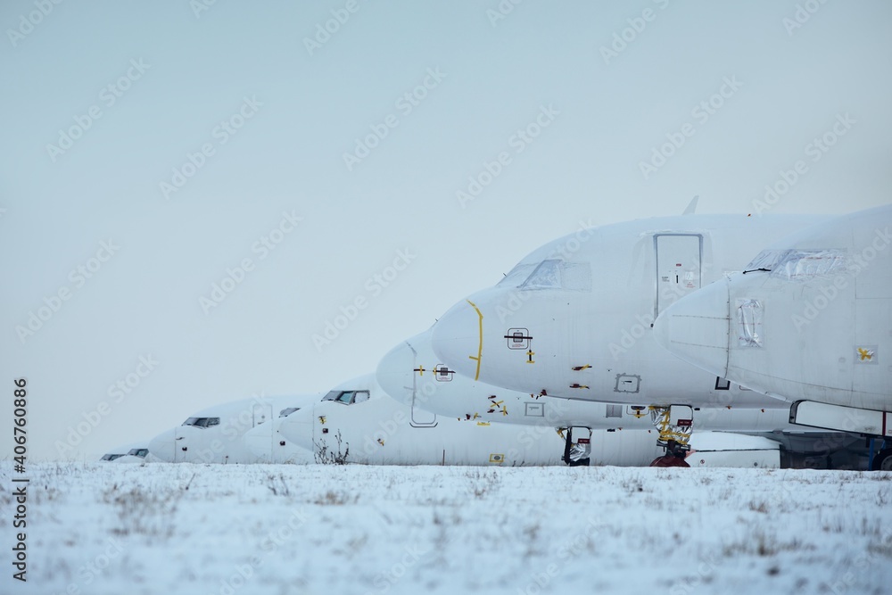 Grounded airplanes in row at airport. One of the symbols global coronavirus crisis. Grounded airplanes in row at airport. One of the symbols global coronavirus crisis.