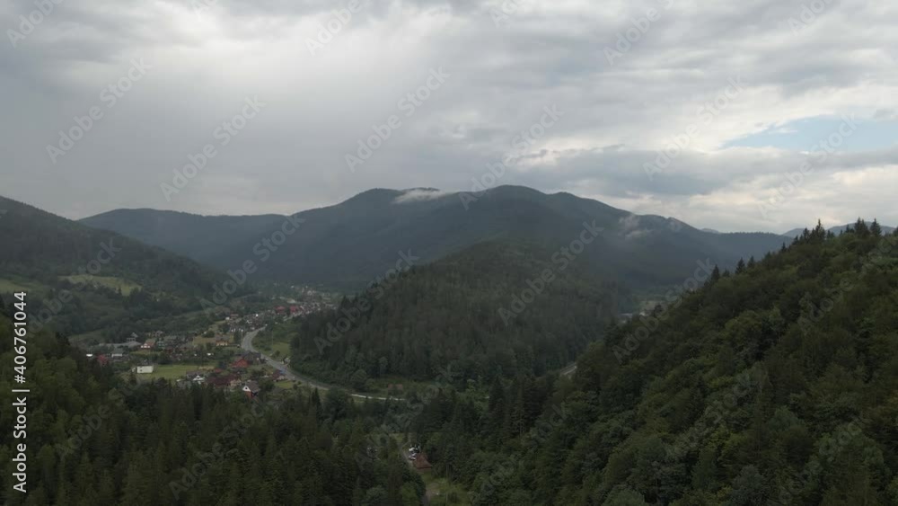 Flying towards valley in Ukraine with tiny village and road. Aerial. Flying towards valley in Ukraine with tiny village and road. Aerial.