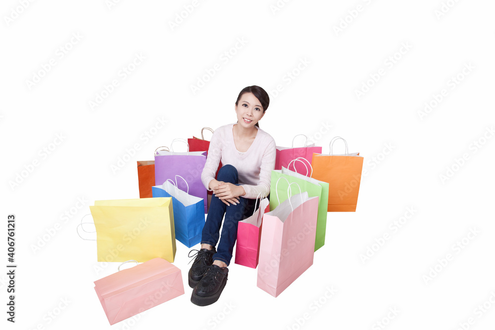 Portrait of young woman sitting among shopping bags,high view Portrait of young woman sitting among shopping bags,high view