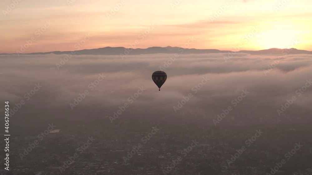 Drone Aerial View, Hot Air Balloon Flying on Scenic Sunset Above Clouds and City of San Miguel de Allende, Mexico Drone Aerial View, Hot Air Balloon Flying on Scenic Sunset Above Clouds and City of San Miguel de Allende, Mexico