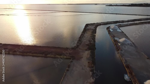 View of Marsala salt flats from drone in flight at sunset in Sicily Italy