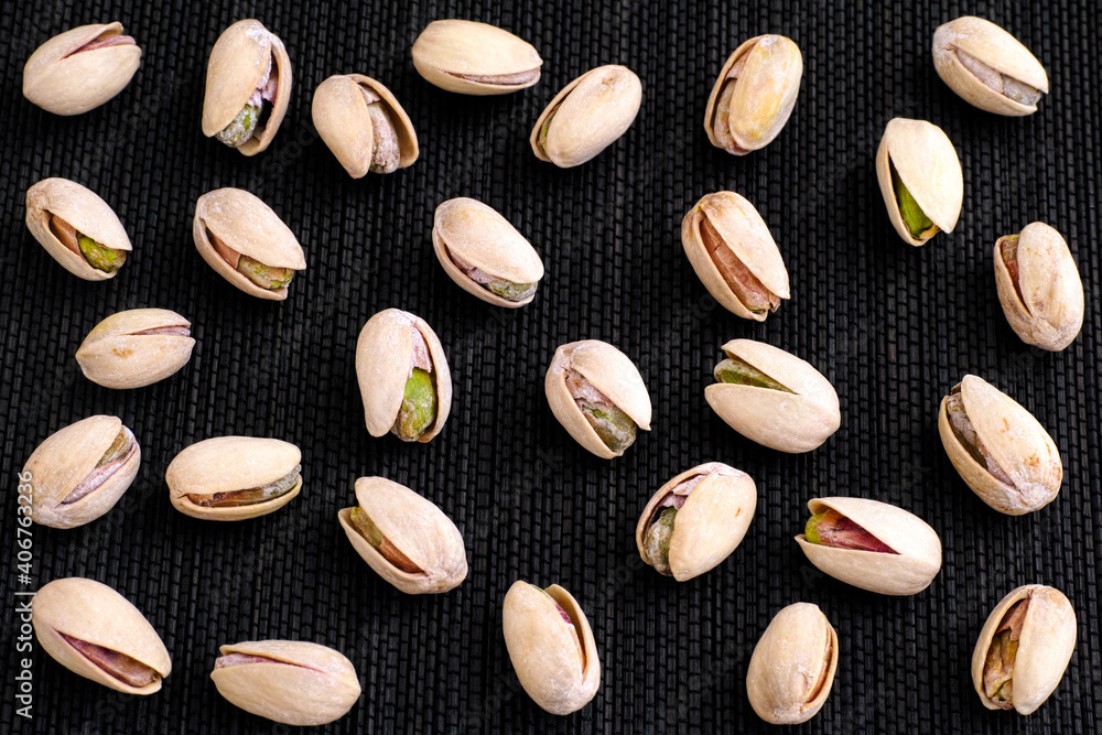 A lot of Pistachio nuts on black napkin A lot of Pistachio nuts on black napkin