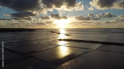 View of Marsala salt flats from drone in flight at sunset in Sicily Italy
