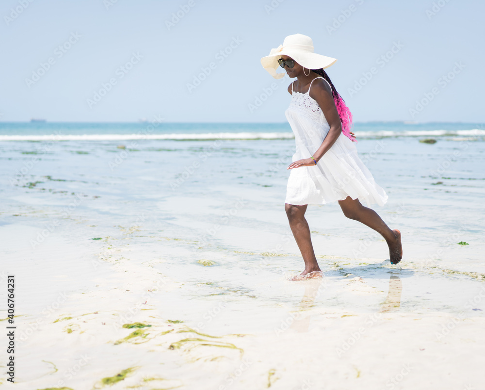 Beautiful young black African American woman on the tropical beach Beautiful young black African American woman on the tropical beach
