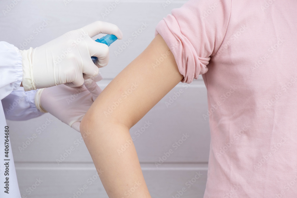 the doctor disinfects the place on the child's hand the doctor disinfects the place on the child's hand