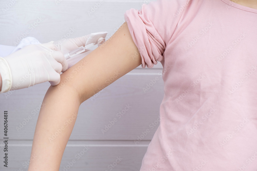 Fototapeta premium the doctor made an injection in the hand of the child
