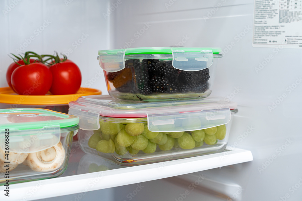 Storage containers with fresh food in a fridge Storage containers with fresh food in a fridge