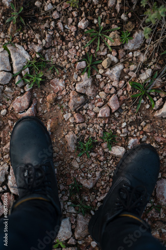 Close-up of a man's black boots while walking in the mountains in Palma de Mallorca