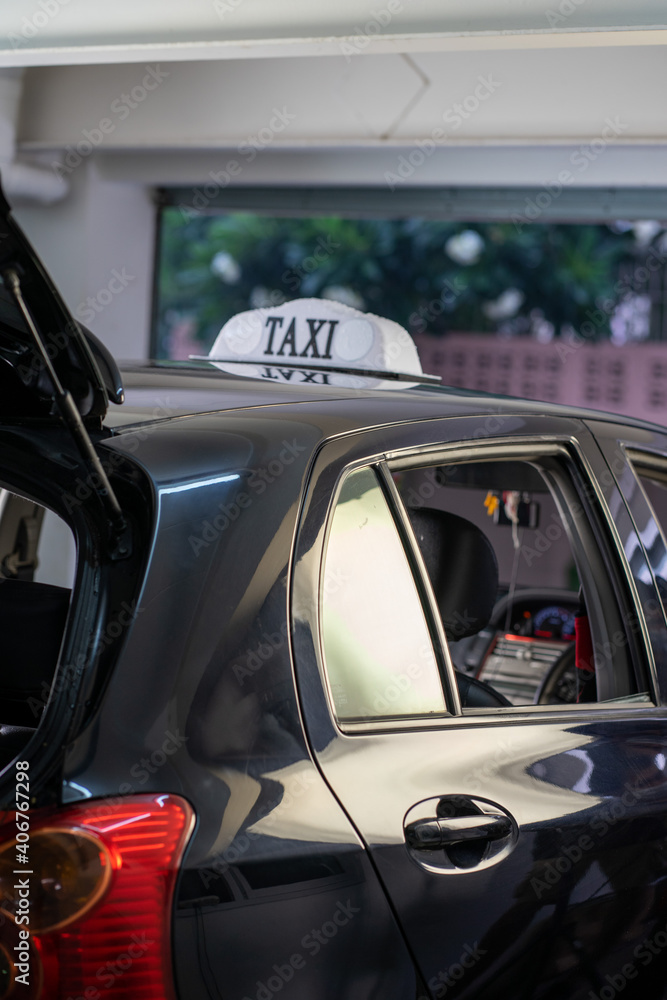 Caucasian young woman wearing protective face mask traveling with taxi and man driver. Caucasian young woman wearing protective face mask traveling with taxi and man driver.