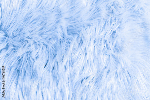 Light blue long fiber soft fur. Blue fur for background or texture. Fuzzy blue fur plaid. Shaggy blanket background. Fluffy fake textile fur. Flat lay, top view, copy space