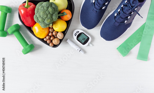 Healthy eating and sport plan for diabetes patients top view on white wooden table.