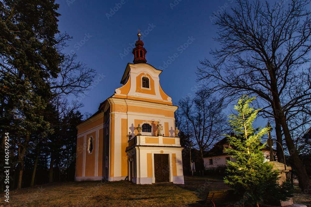 Pilgrimage church of John of Nepomuk in a small Czech village called Svaty Jan, central Bohemia. Evening view of historic catholic church. Religious Christmas background.Dark blue clear sky. Pilgrimage church of John of Nepomuk in a small Czech village called Svaty Jan, central Bohemia. Evening view of historic catholic church. Religious Christmas background.Dark blue clear sky.