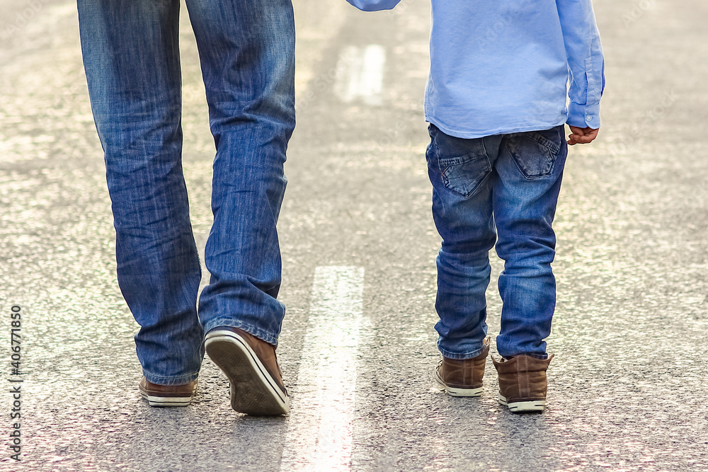 A Happy parent with a child in the park hands on nature travel go along the road A Happy parent with a child in the park hands on nature travel go along the road