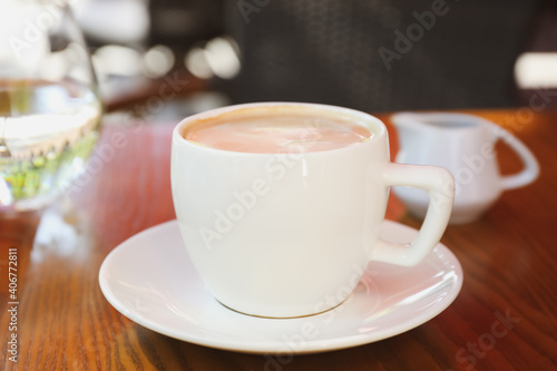 Aromatic coffee on wooden table outdoors, closeup