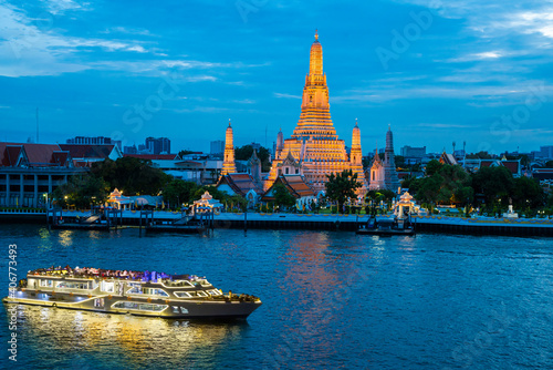 Chao Phraya River Cruise Boat with Temple of the Dawn, Wat Arun, at Sunset in Background, Horizontal © funfunphoto