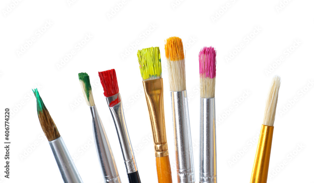 Different brushes with paints on white background Different brushes with paints on white background