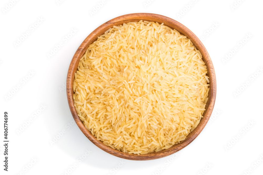 Wooden bowl with raw golden rice isolated on white background. Top view. Wooden bowl with raw golden rice isolated on white background. Top view.