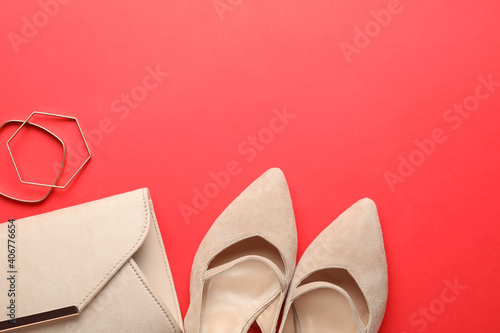 Flat lay composition with stylish women's shoes and accessories on red background, space for text