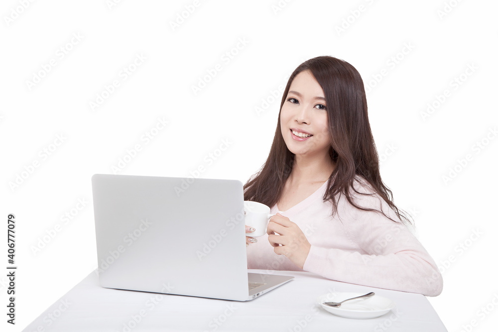 Portrait of young sitting in front of laptop holding coffee cup Portrait of young sitting in front of laptop holding coffee cup