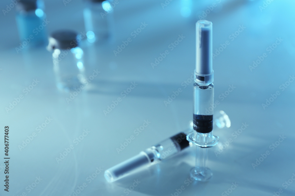 Syringes with COVID-19 vaccine on light table, space for text Syringes with COVID-19 vaccine on light table, space for text