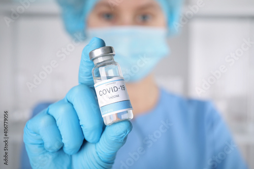 Doctor with coronavirus vaccine in laboratory, focus on hand