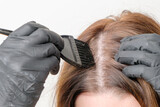Coloring of gray roots of hair at home. Cosmetic procedure at home.