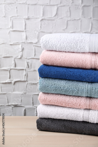 Stacked soft terry towels on wooden table