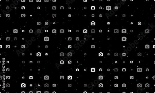 Seamless background pattern of evenly spaced white photo camera symbols of different sizes and opacity. Vector illustration on black background with stars