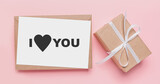 Gifts with note letter on isolated pink background, love and valentine concept with text I love you