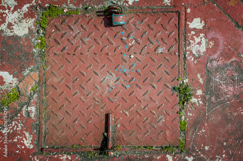 
sewer textured red color texture background old and crumpled metal surface with padlock