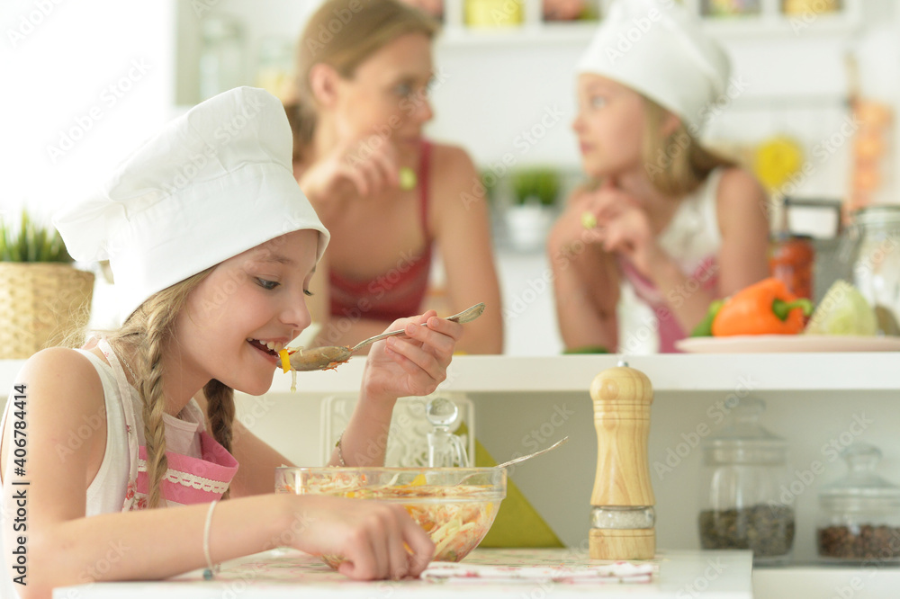 Portrait of cute girl eating salad on kitchen Portrait of cute girl eating salad on kitchen