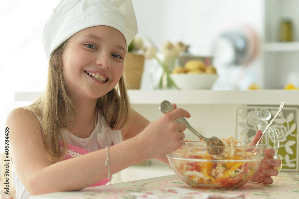 Portrait of cute girl eating salad on kitchen Portrait of cute girl eating salad on kitchen