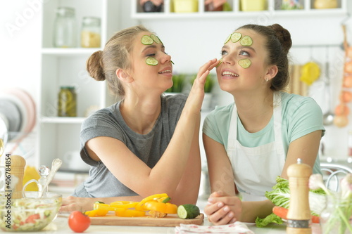 Beautiful teenagers with cucumber slices on faces