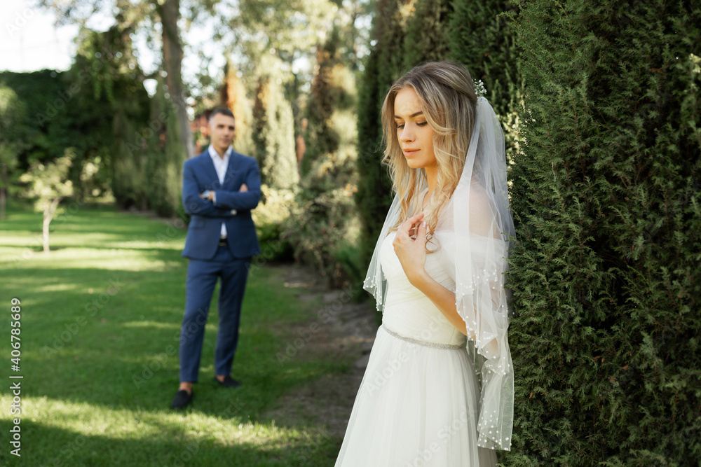 Amazing smiling wedding couple. Pretty bride and stylish groom.