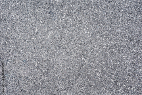 The texture of the gray asphalt pavement. Asphalt empty space.