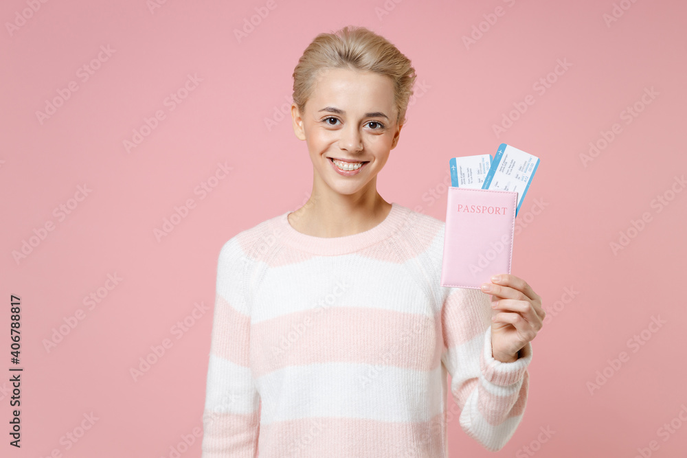 Traveler tourist woman in casual sweater dental braces short haircut hold passport tickets isolated on pastel pink background Passenger traveling abroad on weekends getaway Air flight journey concept Traveler tourist woman in casual sweater dental braces short haircut hold passport tickets isolated on pastel pink background Passenger traveling abroad on weekends getaway Air flight journey concept