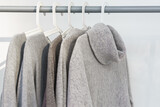 Warm woolen gray women's sweaters on a hanger