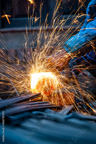 Wallpaper Mural Closeup of a man cutting TMT Steel Bar with circular grinder used in construction. Torontodigital.ca