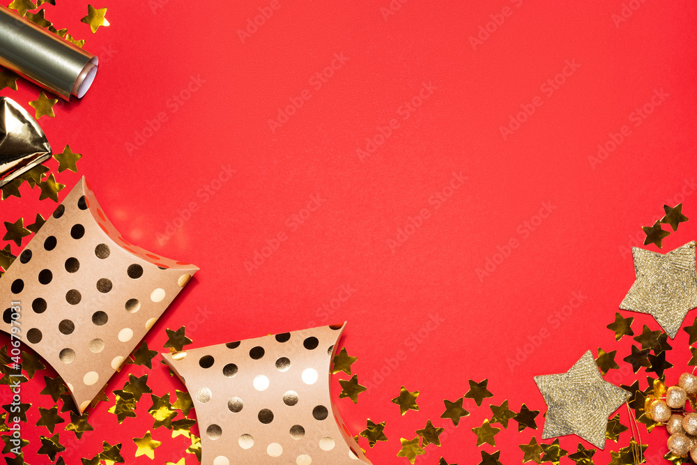 Golden star confetti and gift boxes on red paper background. Valentines day concept. Flat lay and top view, template for copy space