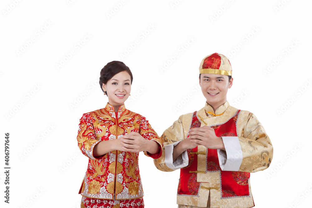 Portrait of young couple in Tang suits paying New Year call 