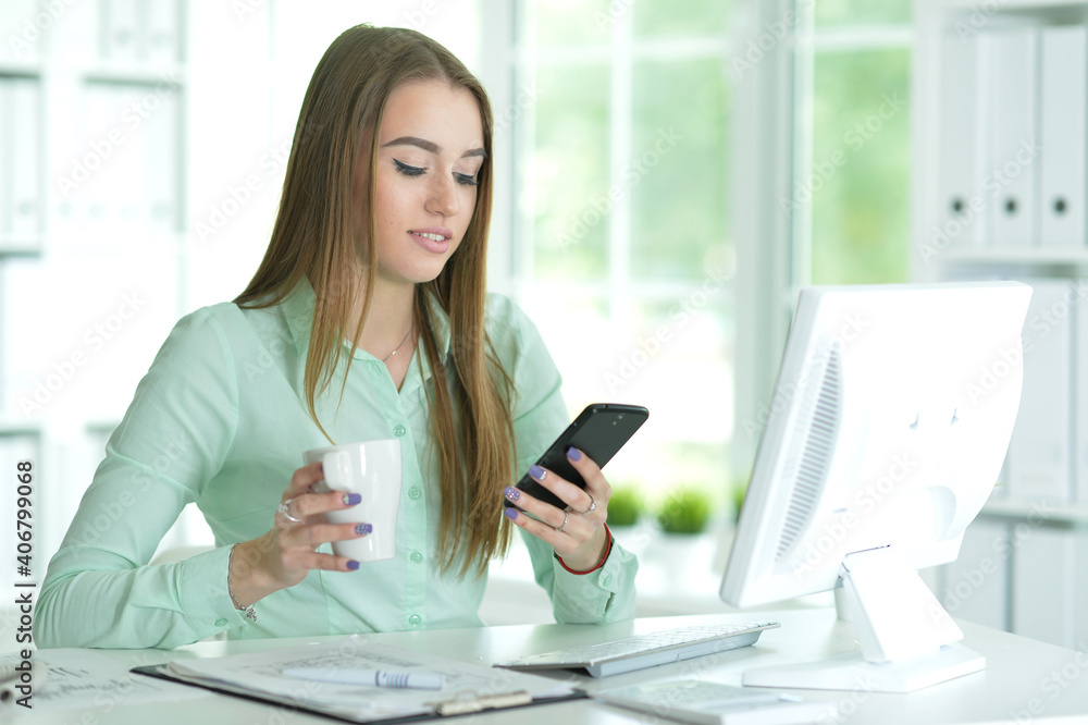 Portrait of businesswoman working in office using smartphone Portrait of businesswoman working in office using smartphone