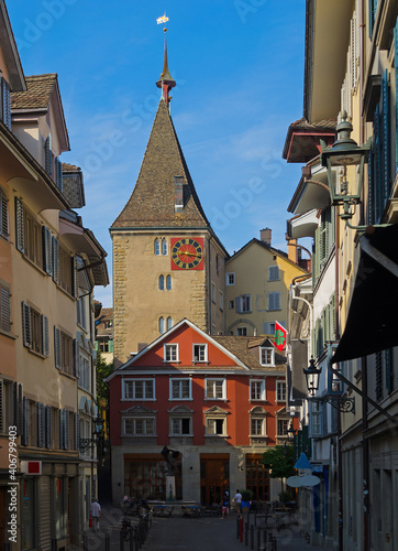 Tower with a red clock on Neumarkt Street in the Rathaus quarter of Zurich, Switzerland